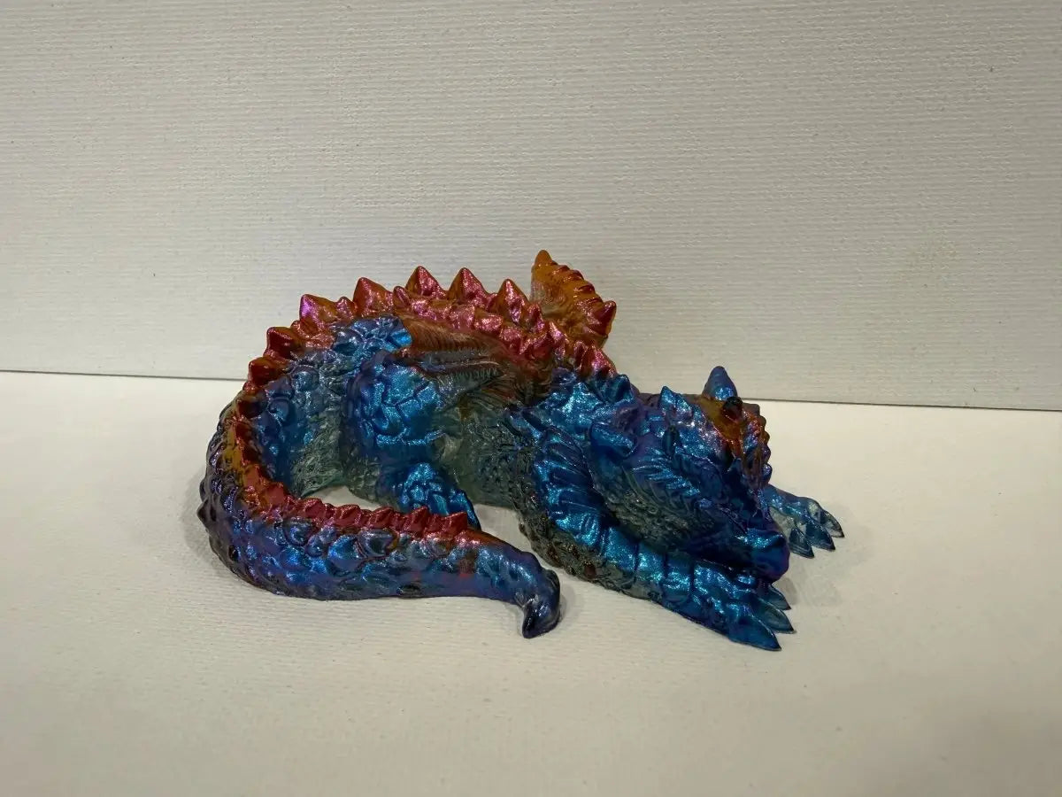 Handmade 4 inch sleeping baby dragon figurine in metallic blue and copper epoxy resin